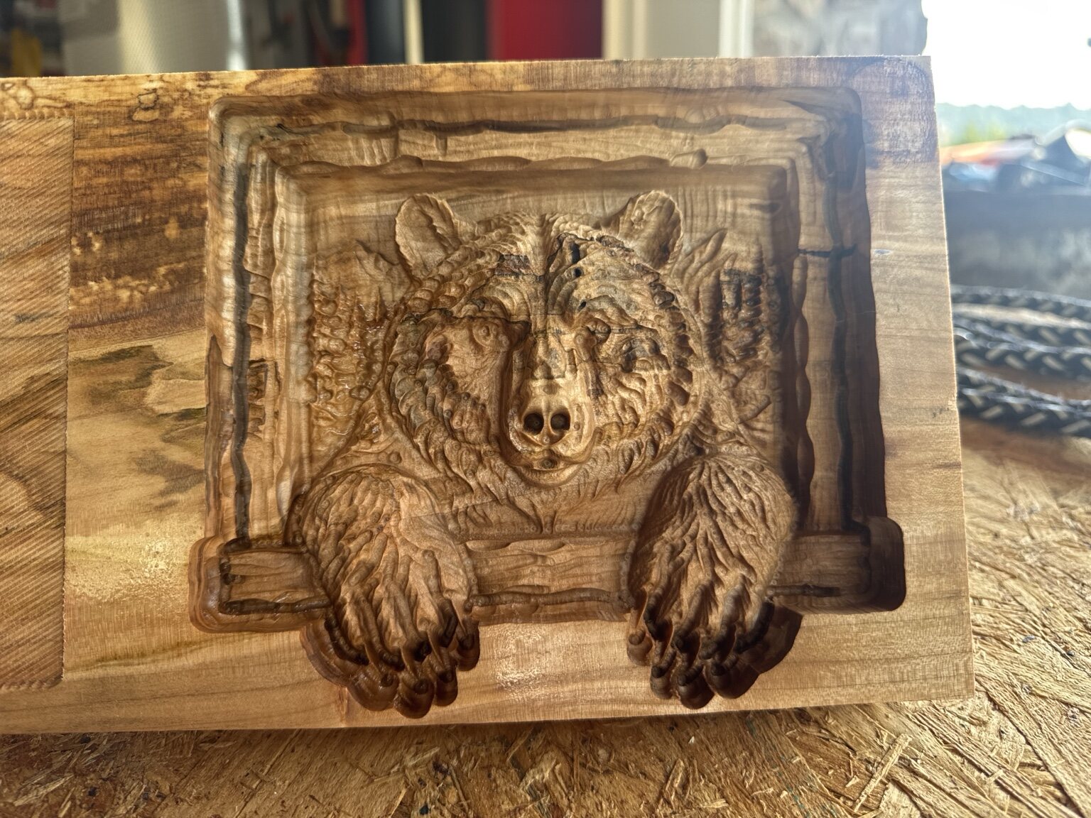 Bear leaning through a carved rustic window frame