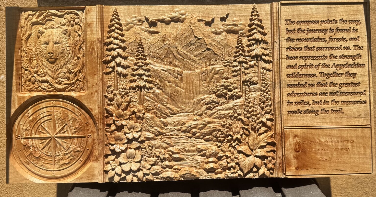 Detailed Appalachian mountain, waterfall, bear, dogwood, and compass scene carved in wood