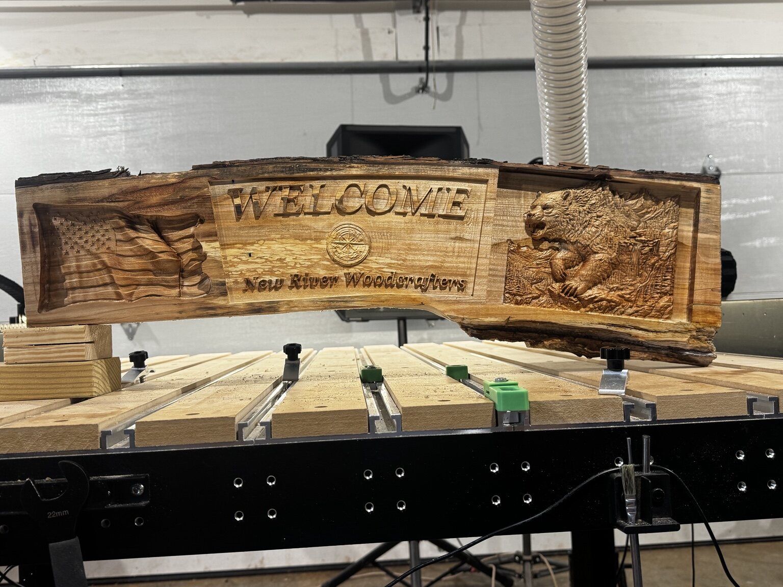 Wide rustic welcome sign with New River scenes