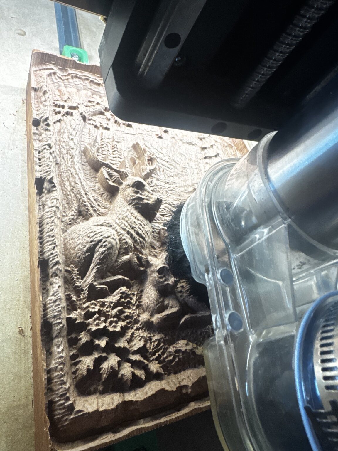 Carving tool beginning a deer family relief