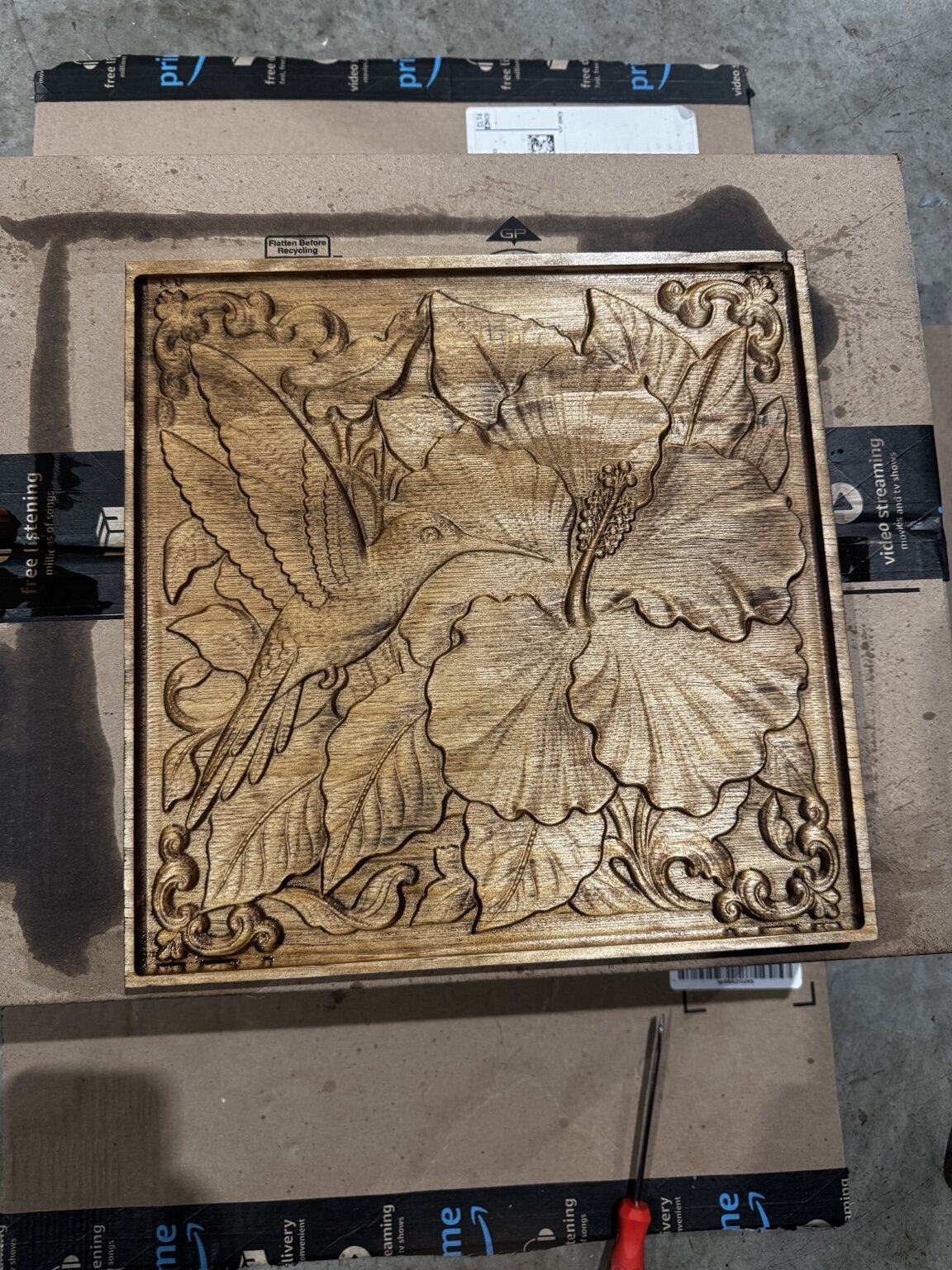Hummingbird and hibiscus flowers carved in wood